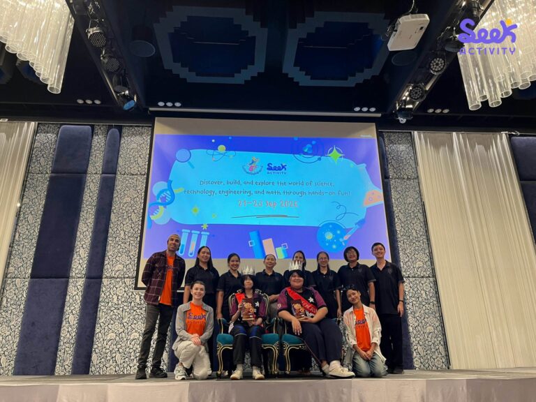 นักเรียนและผู้ร่วมกิจกรรมถ่ายภาพบนเวที หน้าจอแสดงชื่อ Seek Activity และวันที่ 21–23 กันยายน 2026